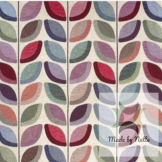 Fashion tapestry fabric featuring a colourful, repeating leaf-inspired design.