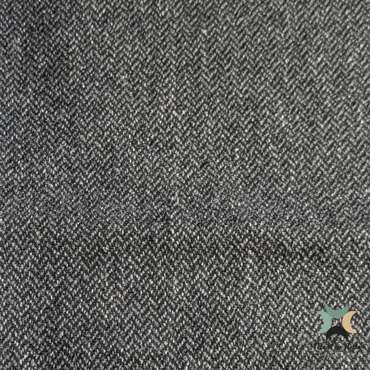 A dark, textured Orkney Tweed Style fabric with a subtle, understated appearance.