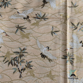 A patterned cotton fabric featuring green, cream and gold tones for a fresh, elegant look.