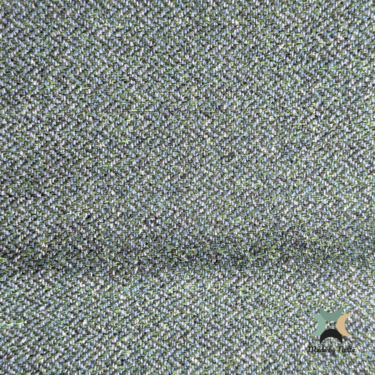A textured Orkney Tweed Style fabric featuring a rich blend of blue and green tones.