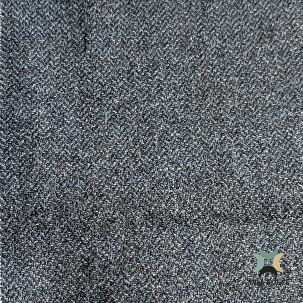 A textured Orkney Tweed Style fabric in ocean-inspired blue and grey tones.