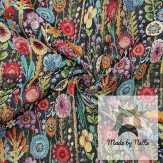 Kew Gardens tapestry fabric featuring a colourful botanical design against a dark background.