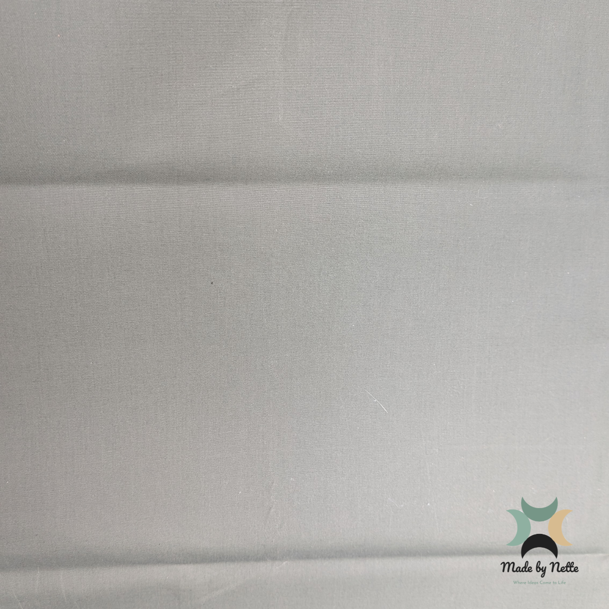 A light moss-green waxed canvas offering a muted, earthy colour for suitable handmade bag designs.